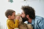 Dad And Son Kissing Teddy Bear. by Guille Faingold